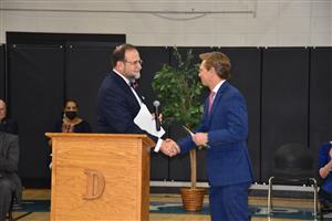 Dr. Nichols welcoming Dr. Mackey at the podium